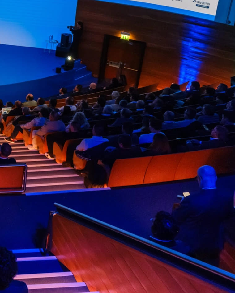 A full auditorium watching the programme